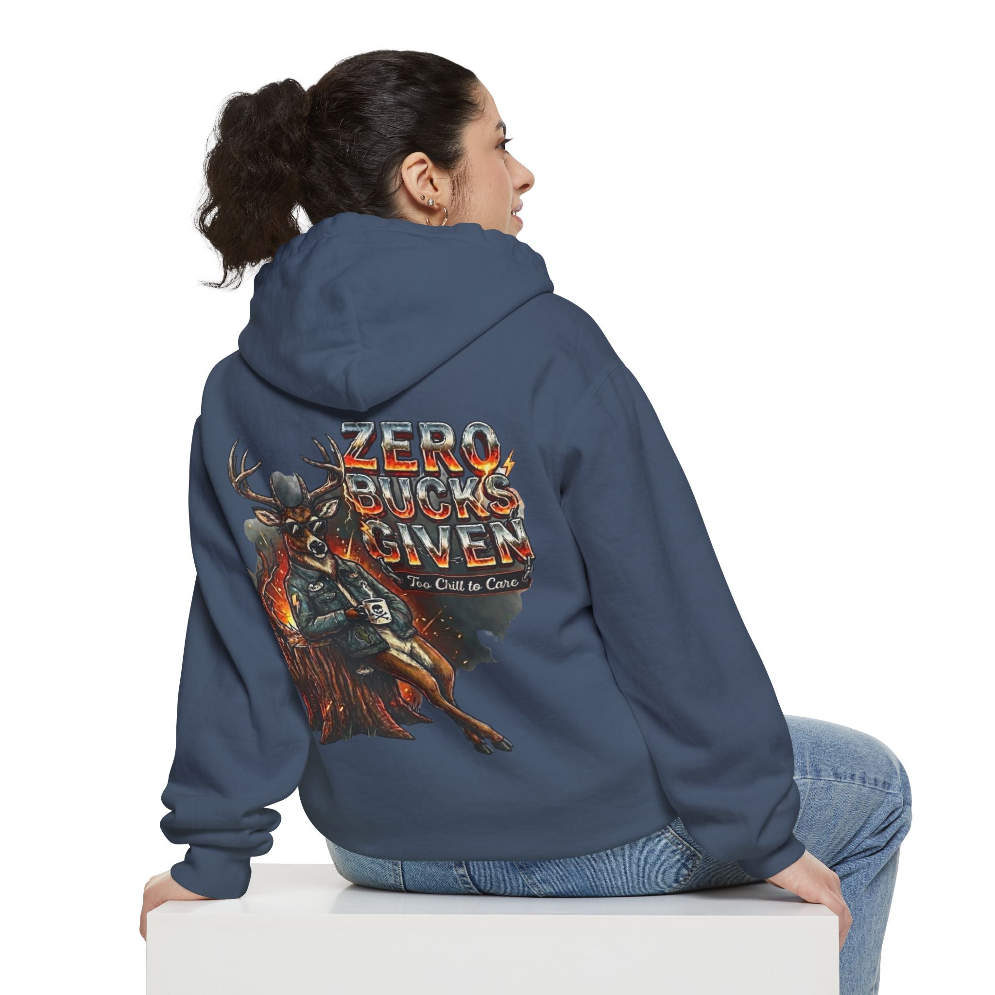 Person wearing a blue hoodie with a graphic design on the back, sitting on a white surface.