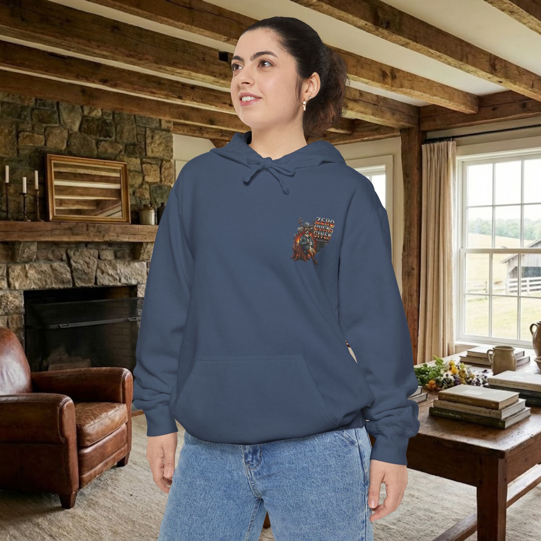 Woman wearing a blue hoodie with a pocket design in a cozy living room.