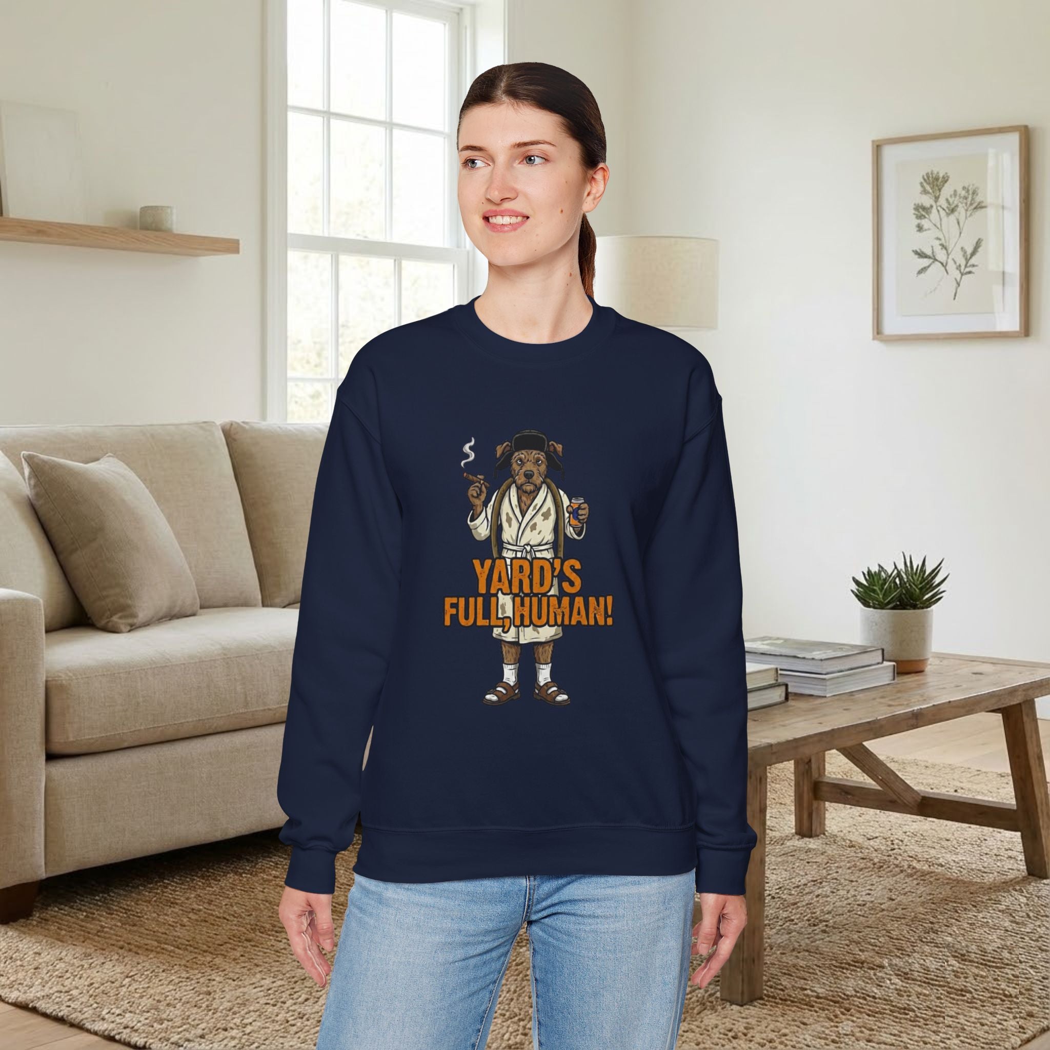 Woman wearing a navy blue sweatshirt with a graphic design in a living room.