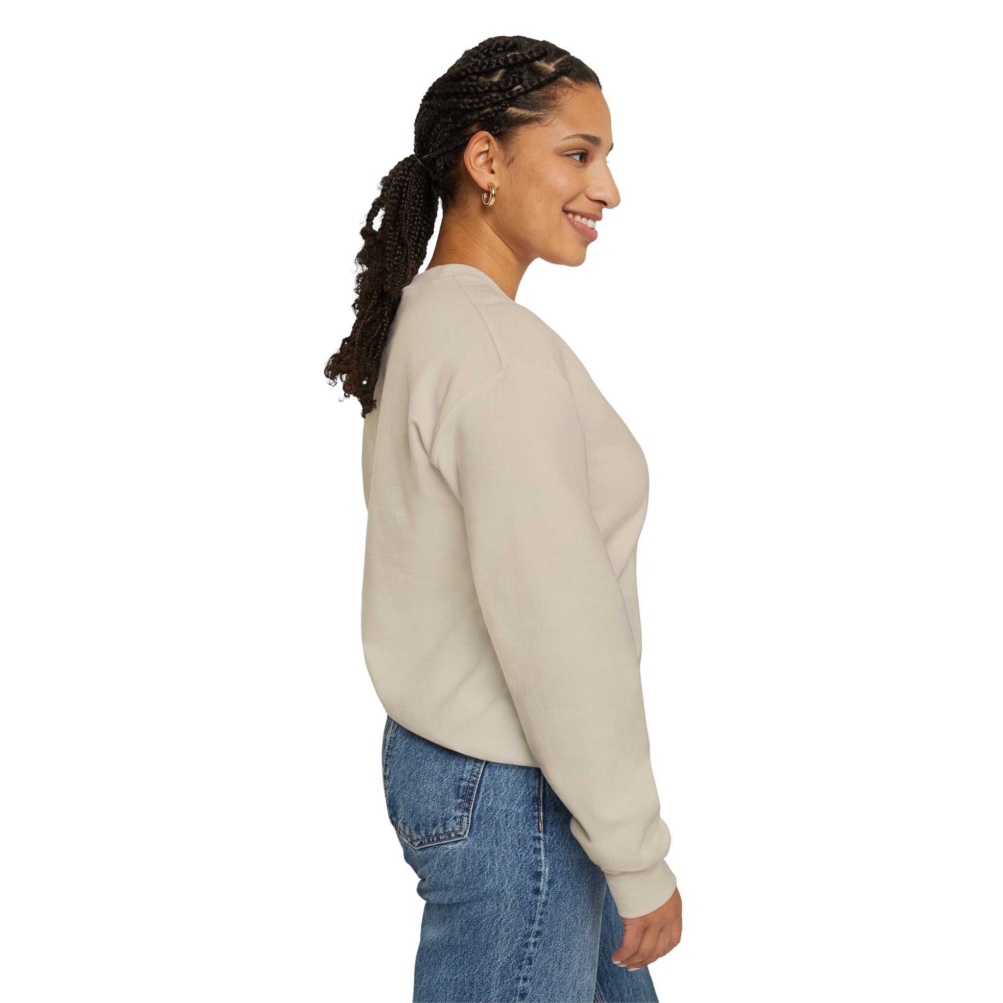 Woman wearing a beige sweatshirt and blue jeans on a white background