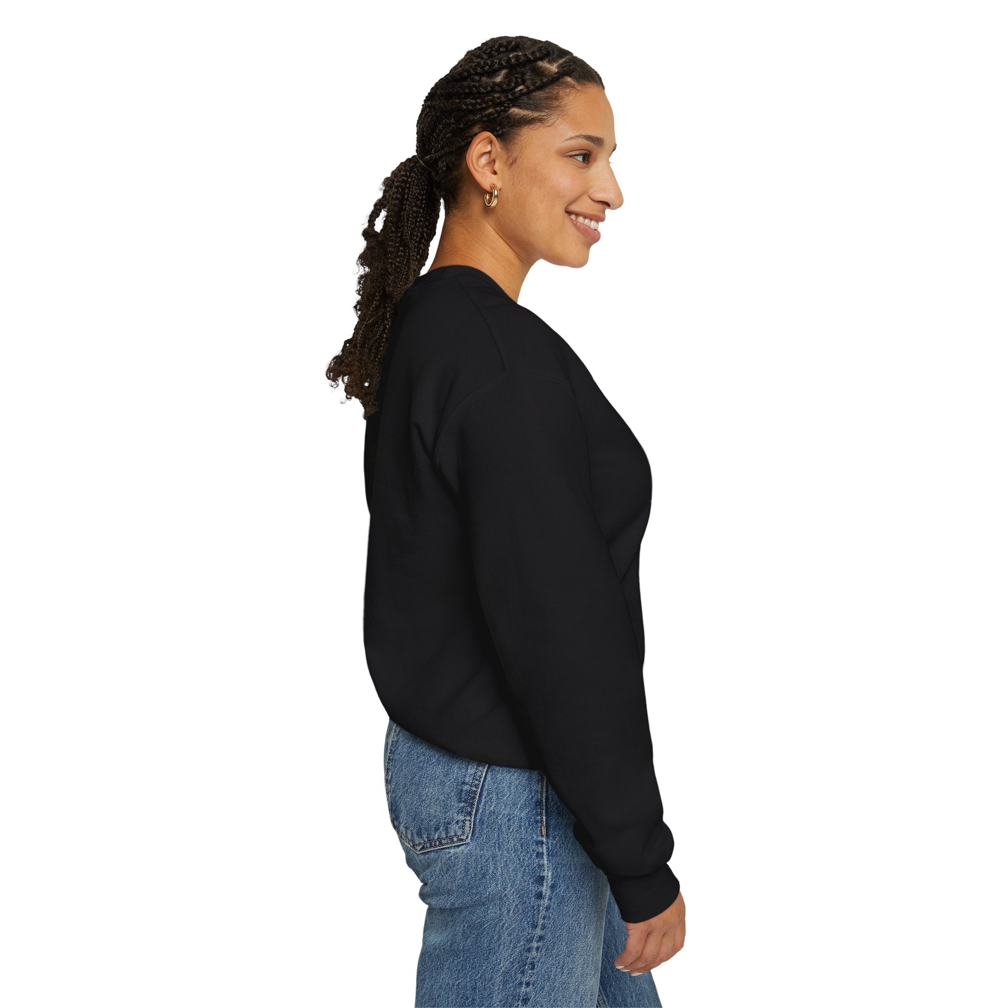 Woman wearing a black sweatshirt and blue jeans on a white background