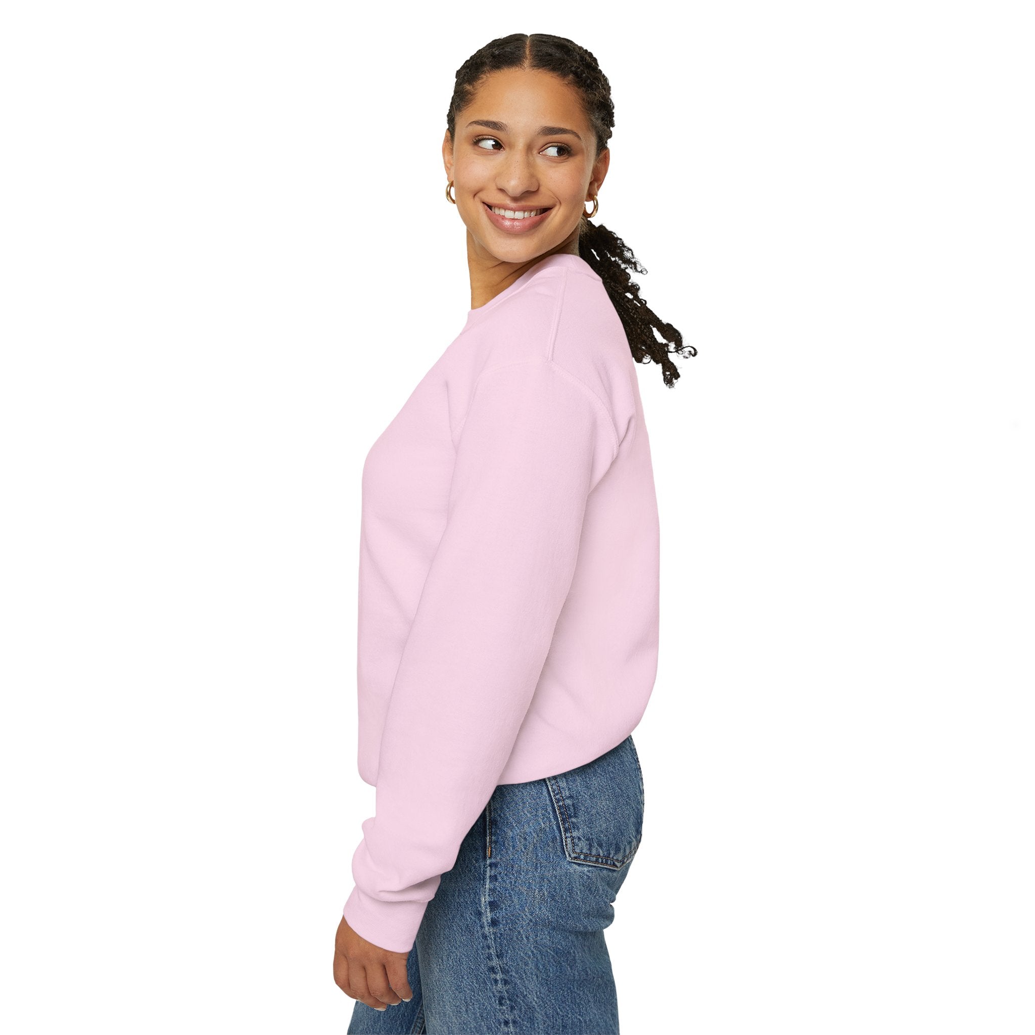 Woman wearing a light pink sweatshirt and blue jeans on a white background