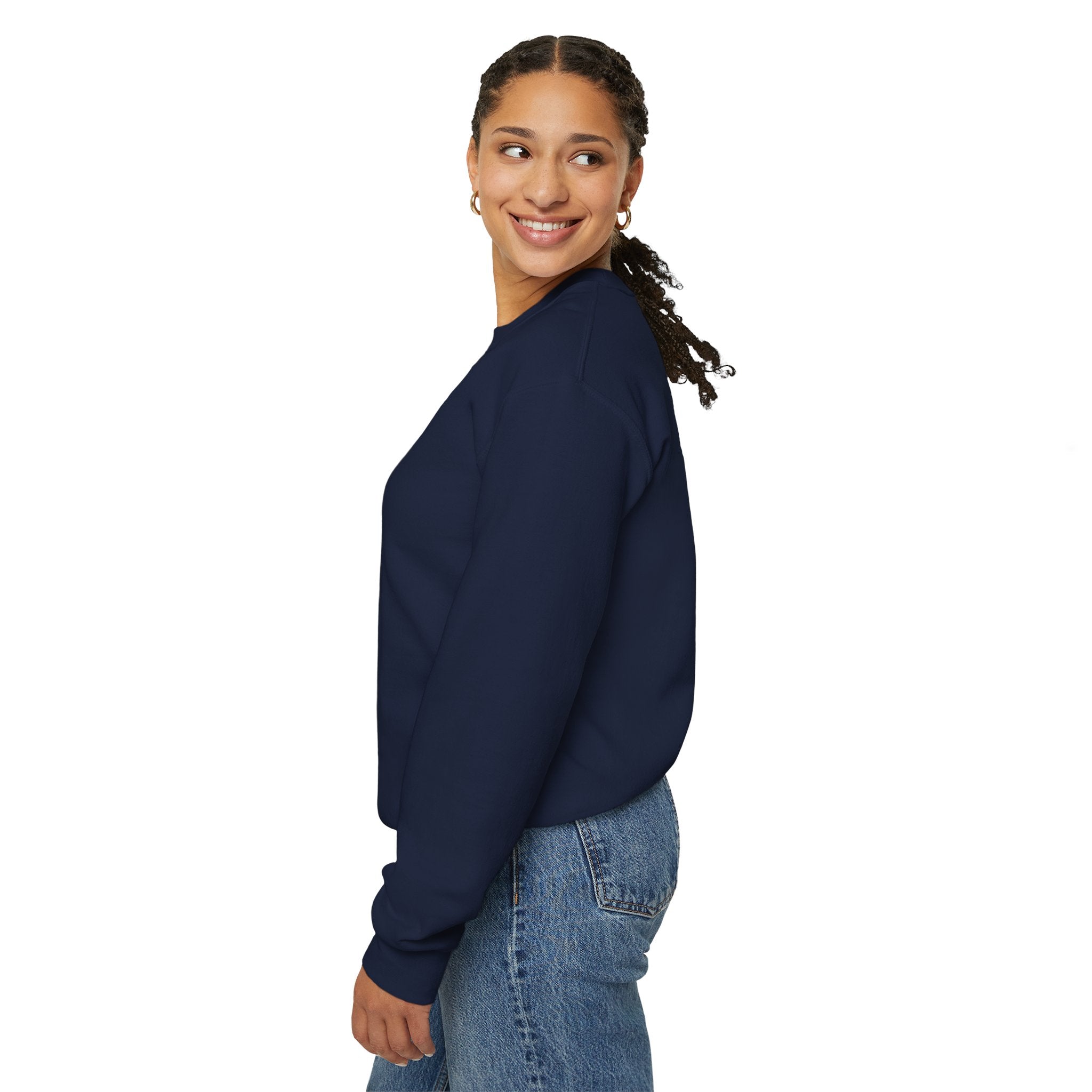 Woman wearing a navy blue sweatshirt and jeans on a white background
