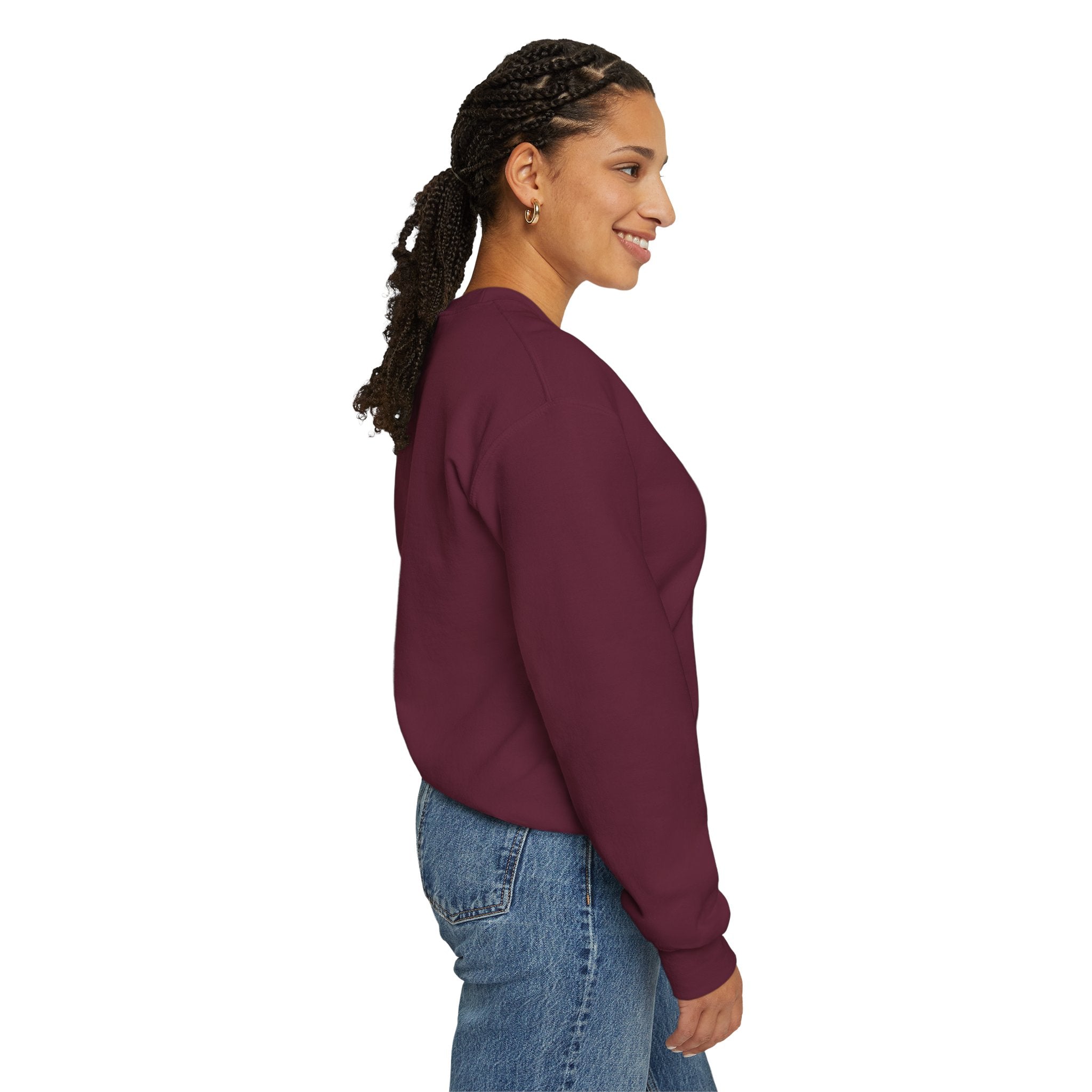 Woman wearing a maroon sweatshirt and blue jeans on a white background