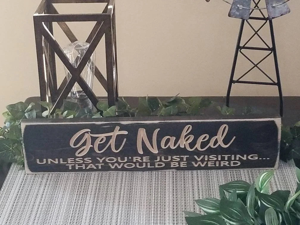 Decorative wood sign with playful bathroom humor for housewarming gifts.
