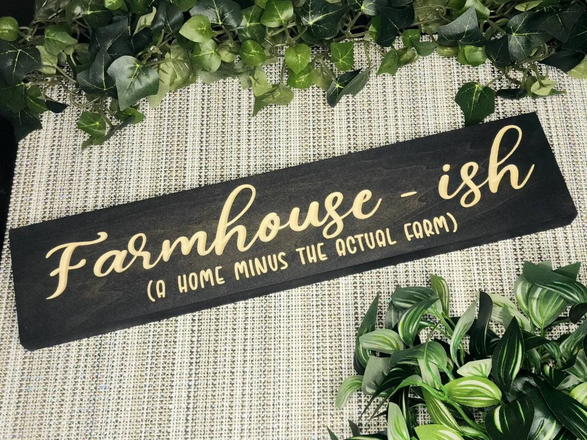 "Farmhouse-ish (A Home Minus the Actual Farm)" sign displayed as rustic farmhouse wall art in a modern home.