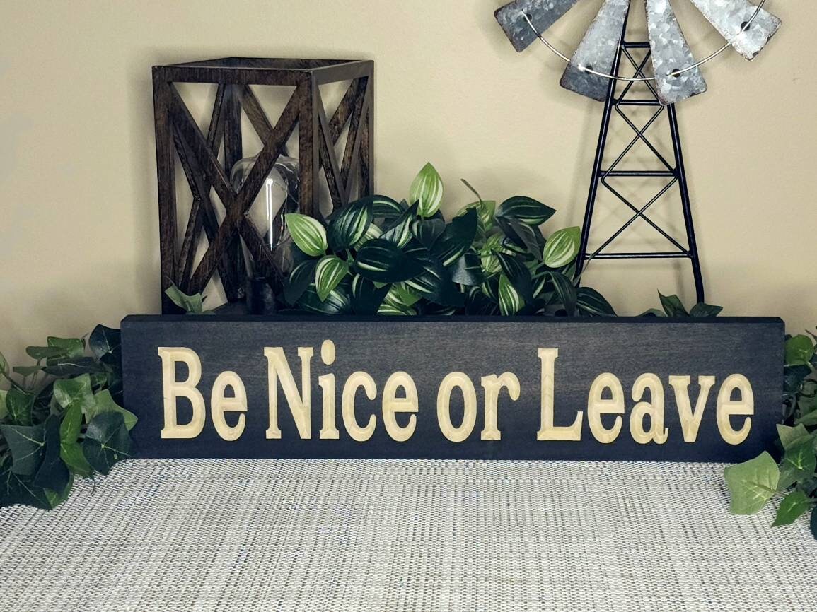 Funny wooden sign with a kindness message hanging in a small business space.