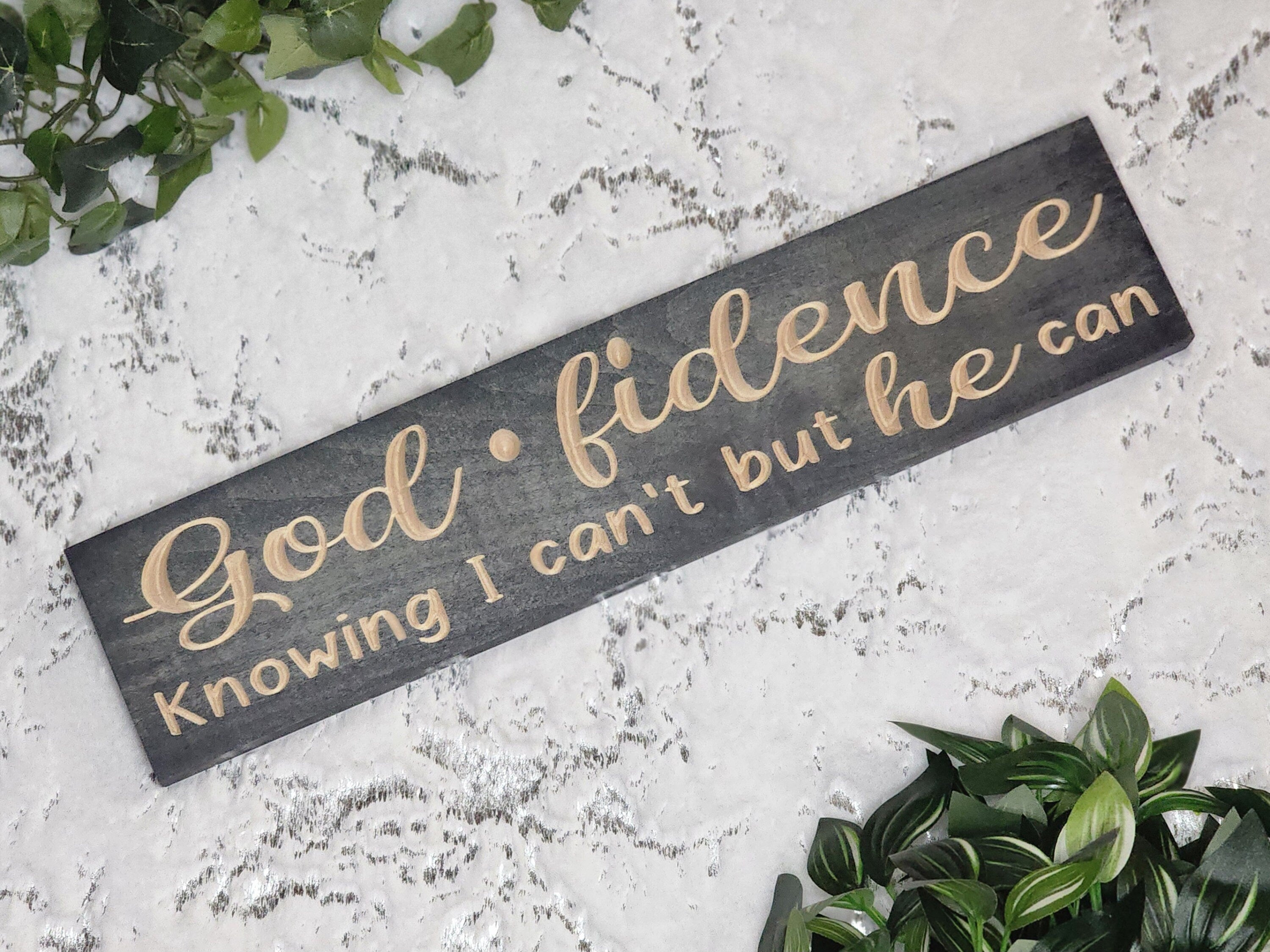 Godfidence wooden sign displayed in a serene prayer room setting.