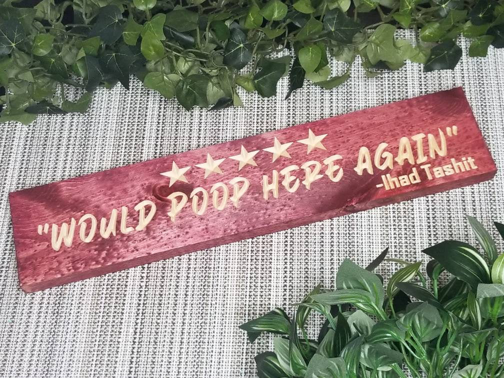 Quirky bathroom decor with humorous poop review wall art for playful homes.
