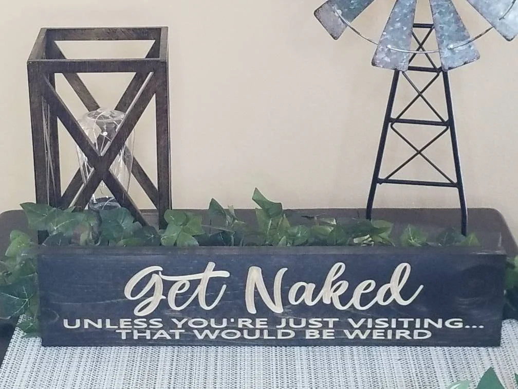 Rustic bathroom wall art with humorous quote for guest bathroom décor.