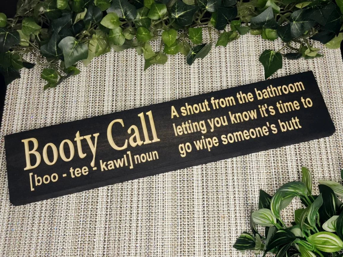 Rustic wooden bathroom sign reading Booty Call - A shout from the bathroom letting you know it's time to go wipe someone's butt in a cozy family bathroom.