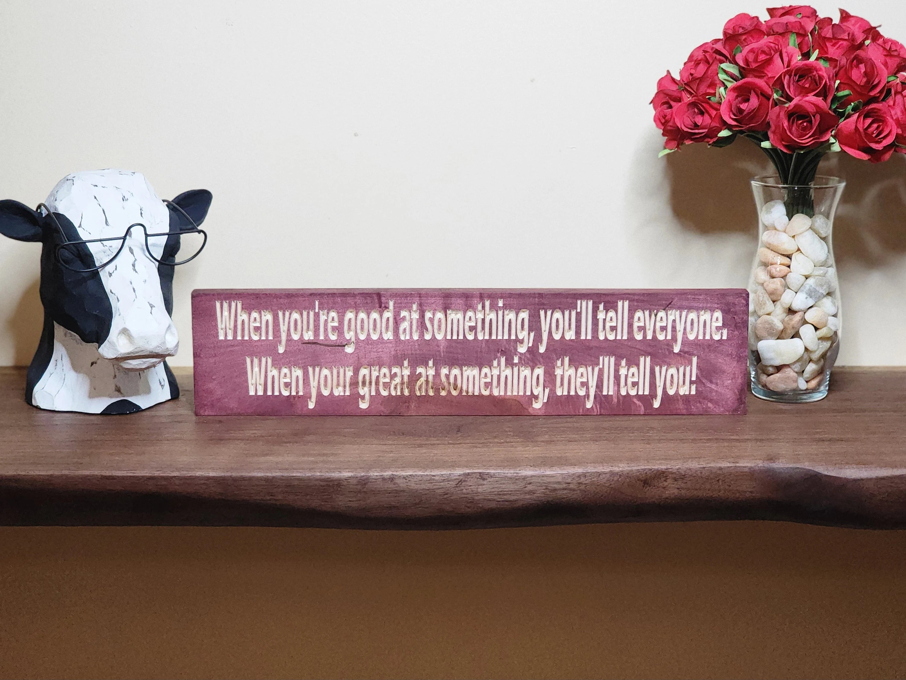 Rustic wooden motivational sign styled on a study room wall for daily inspiration.
