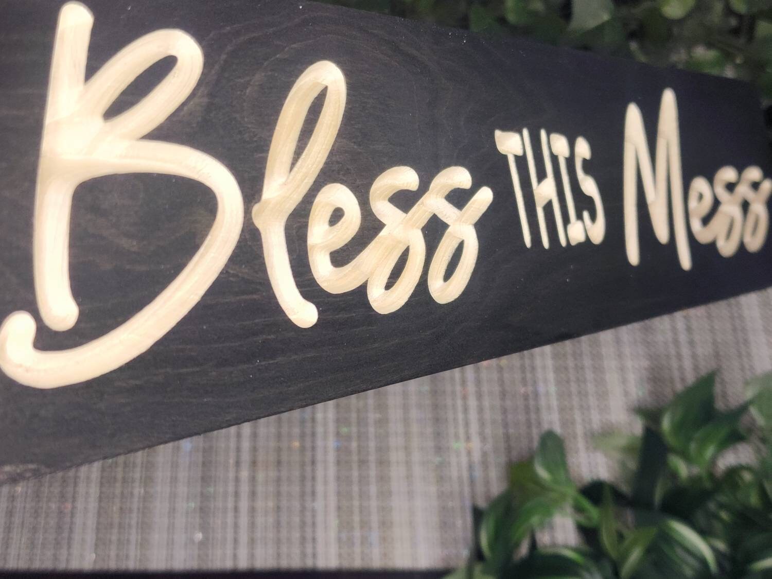 Wooden Bless This Mess sign styled in a rustic kitchen setting.