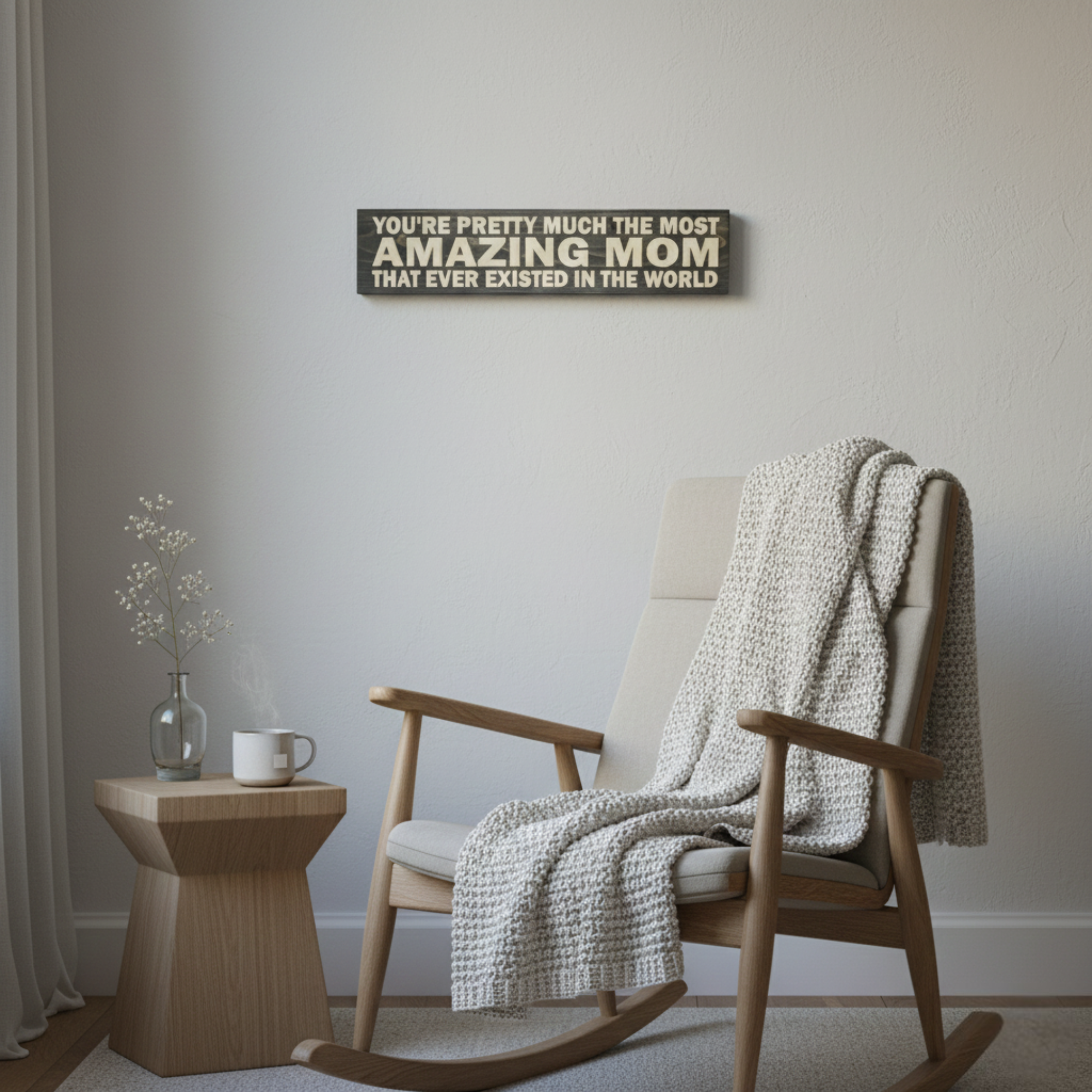 Handcrafted wood sign hanging in a cozy living room or nursery above a modern rocking chair.