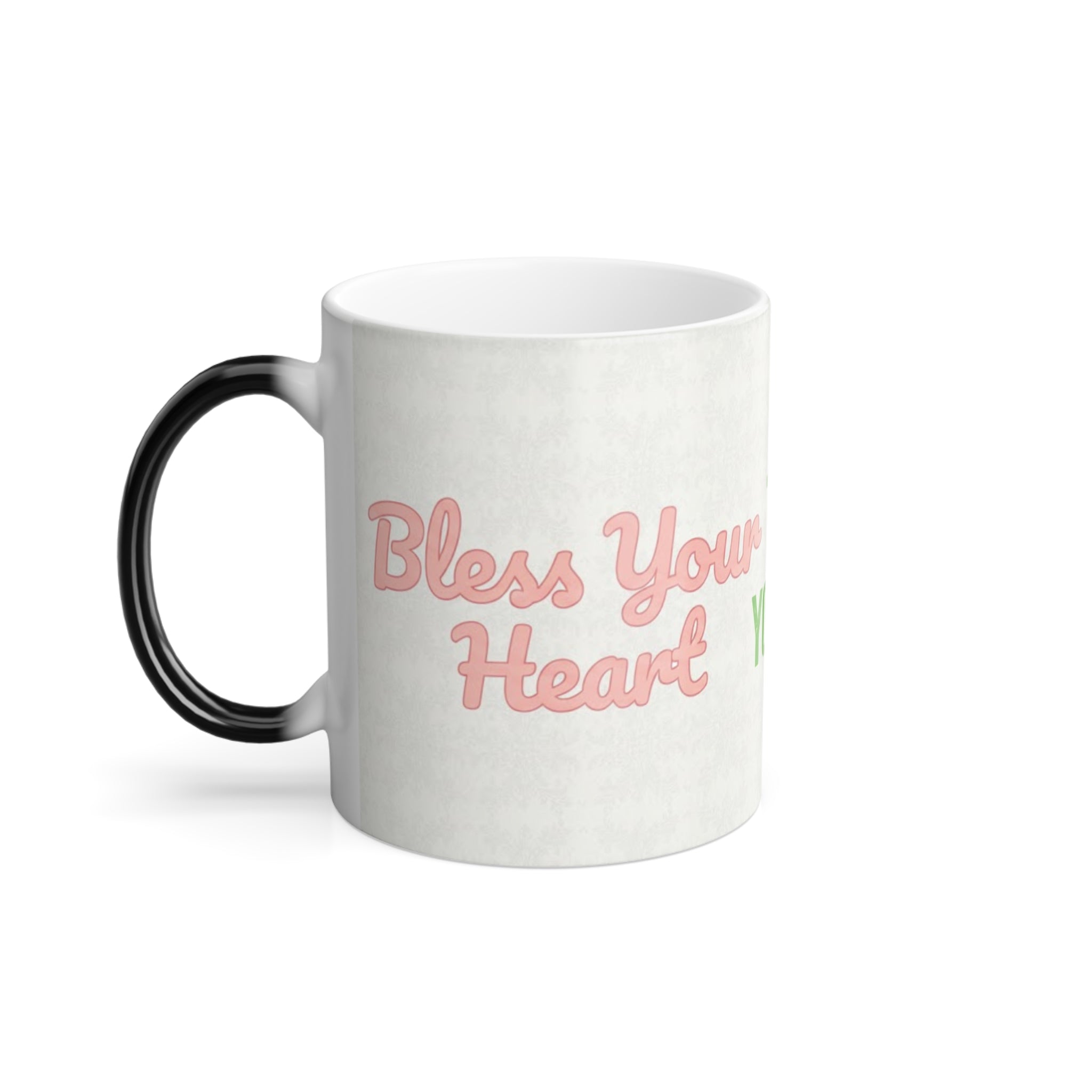 Left side of Bless Your Heart magic mug showing pink script southern saying on white heat-activated surface.