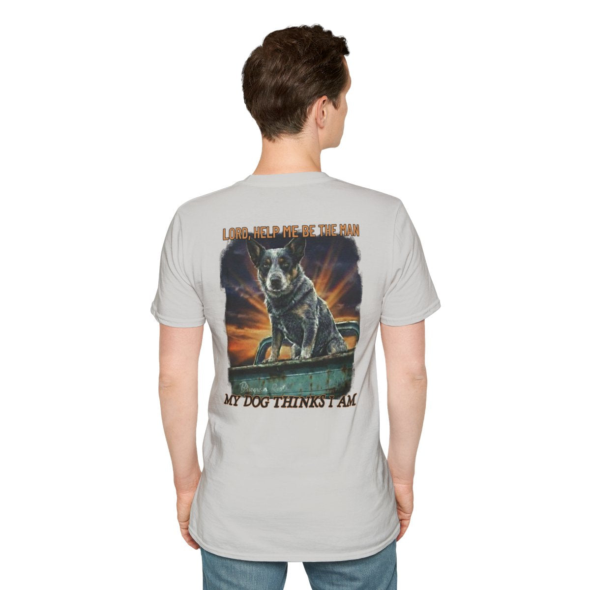 A man from behind wears a light gray Blue Heeler Shirt, featuring a large dog in a truck and text on the back