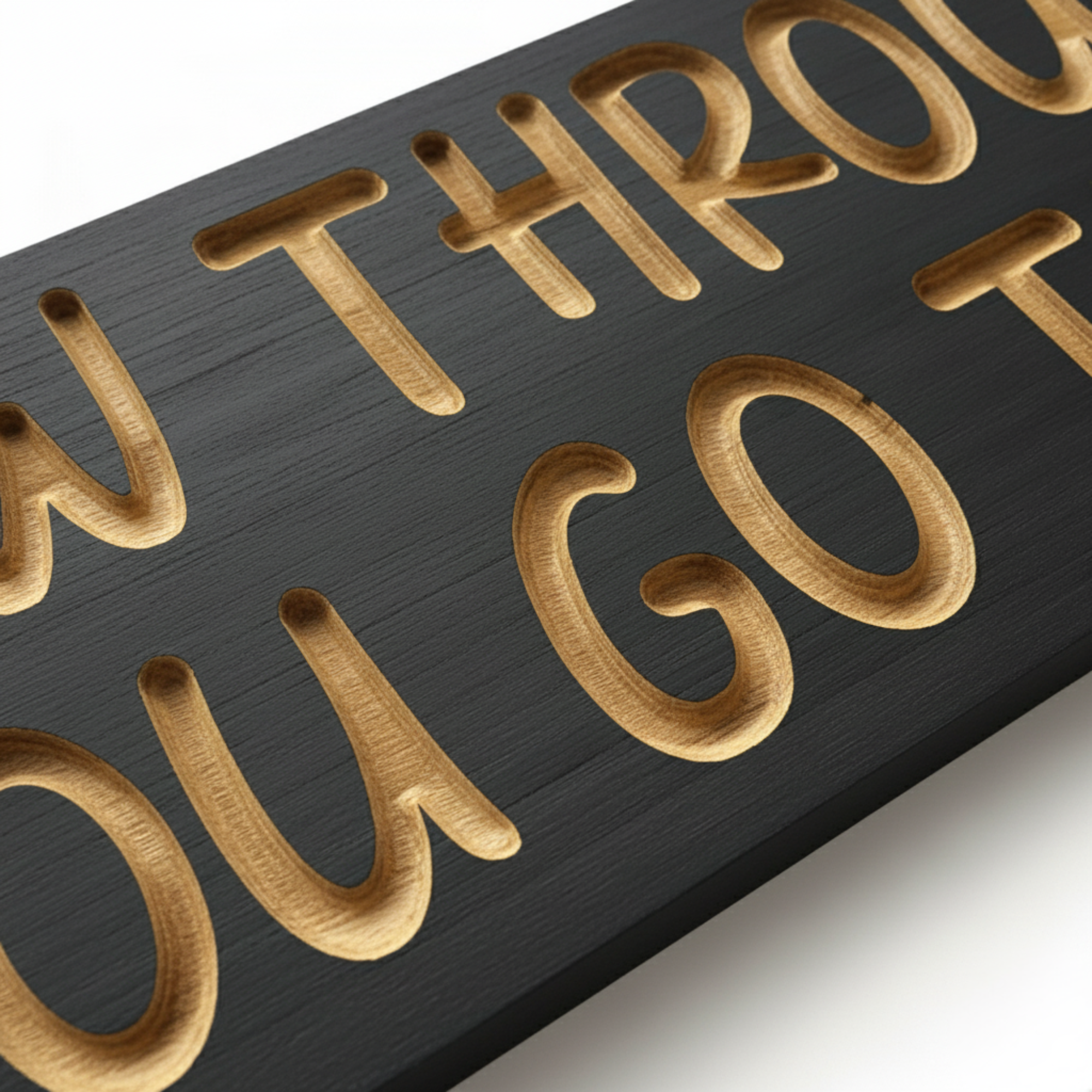 Close‑up of carved letter depth and brushed‑gold finish on the “Grow Through What You Go Through” wood sign.