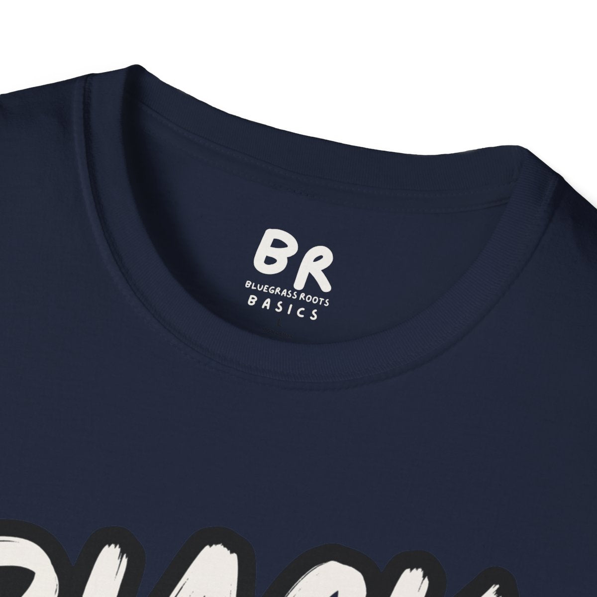 Close-up of the collar of a navy blue tee, showing the Bluegrass Roots Basics tag above the "Cattle Shirt - Black Baldy" graphic