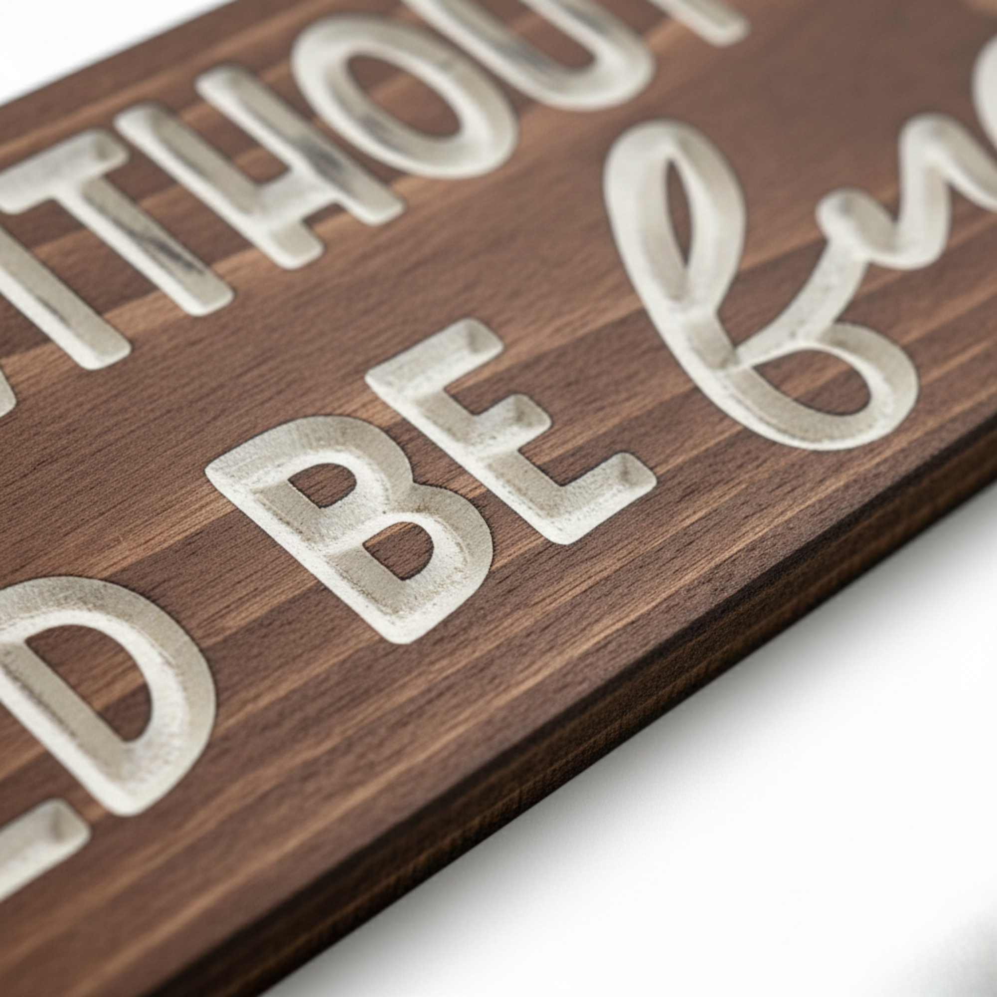 Macro detail shot showcasing the high-quality CNC carving and natural grain of a Bluegrass Gifts solid wood sign.