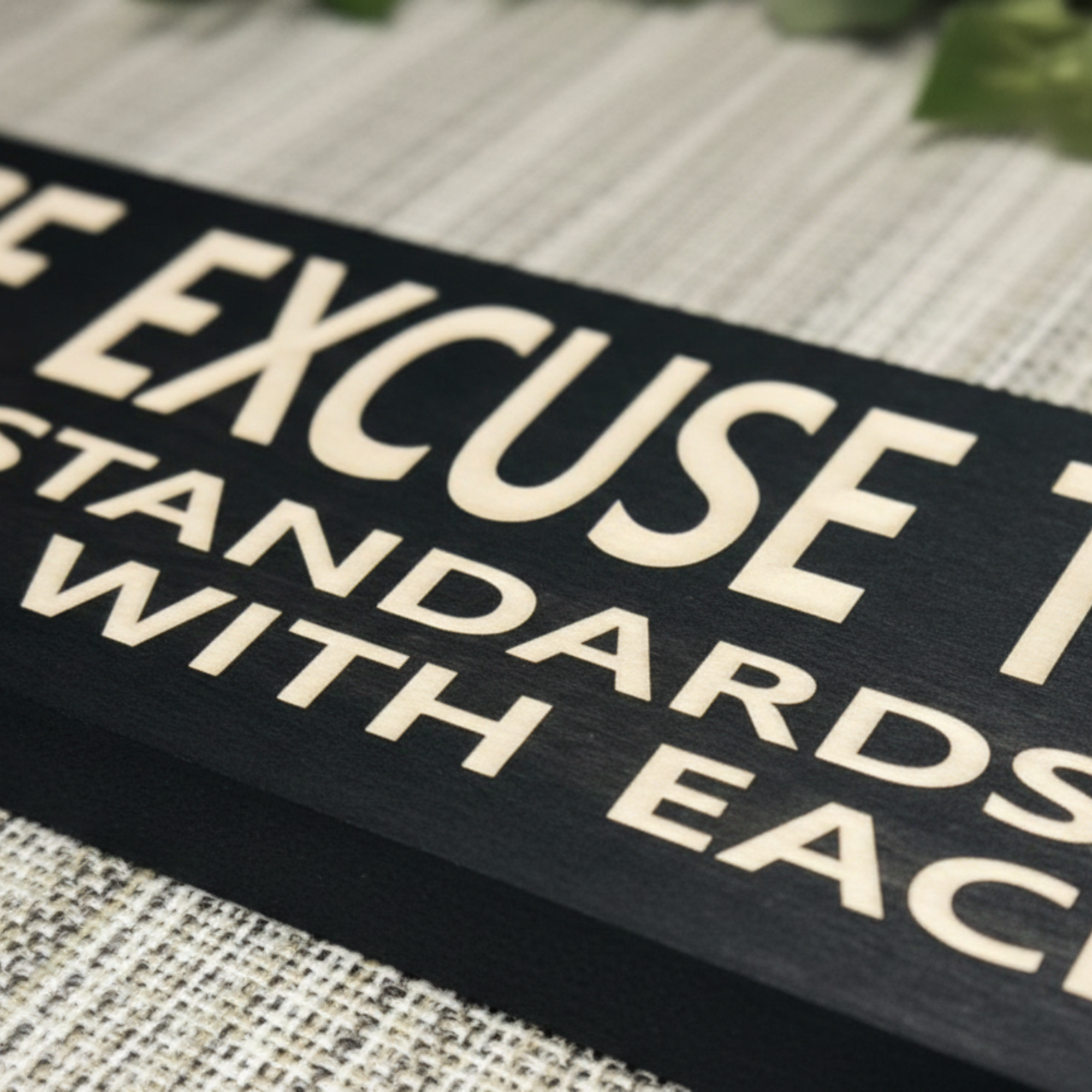 Macro detail of the high-quality CNC carving on a Bluegrass Gifts wood sign, showing the precision of the engraved letters "STANDARDS WITH EACH CHILD".