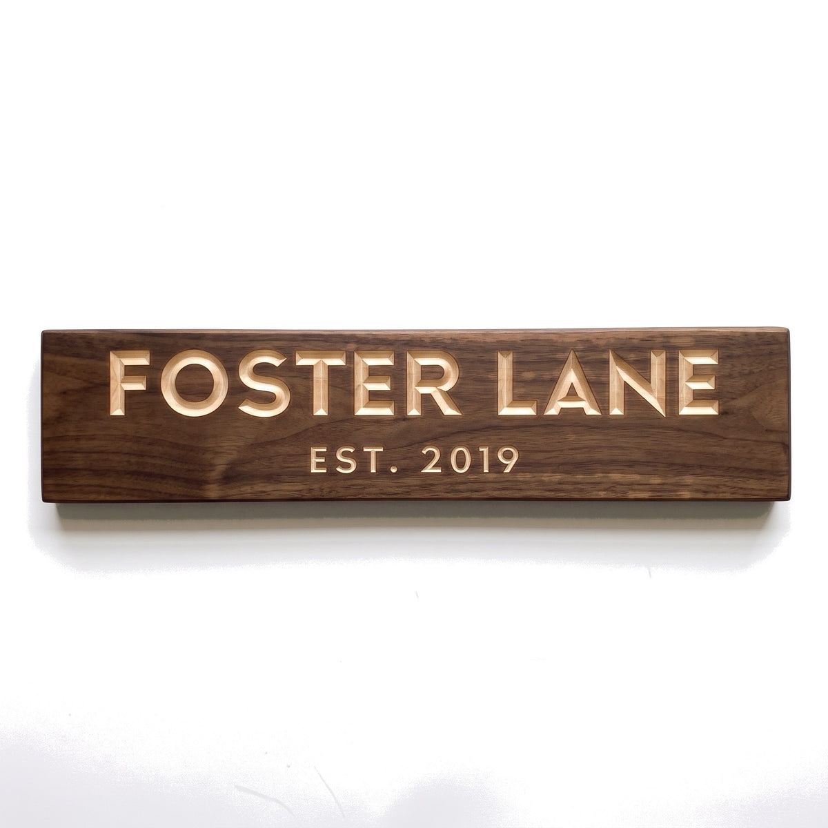Personalized Foster Lane sign carved into solid wood in a Dark Walnut finish, straight on, on a white background (studio photo)