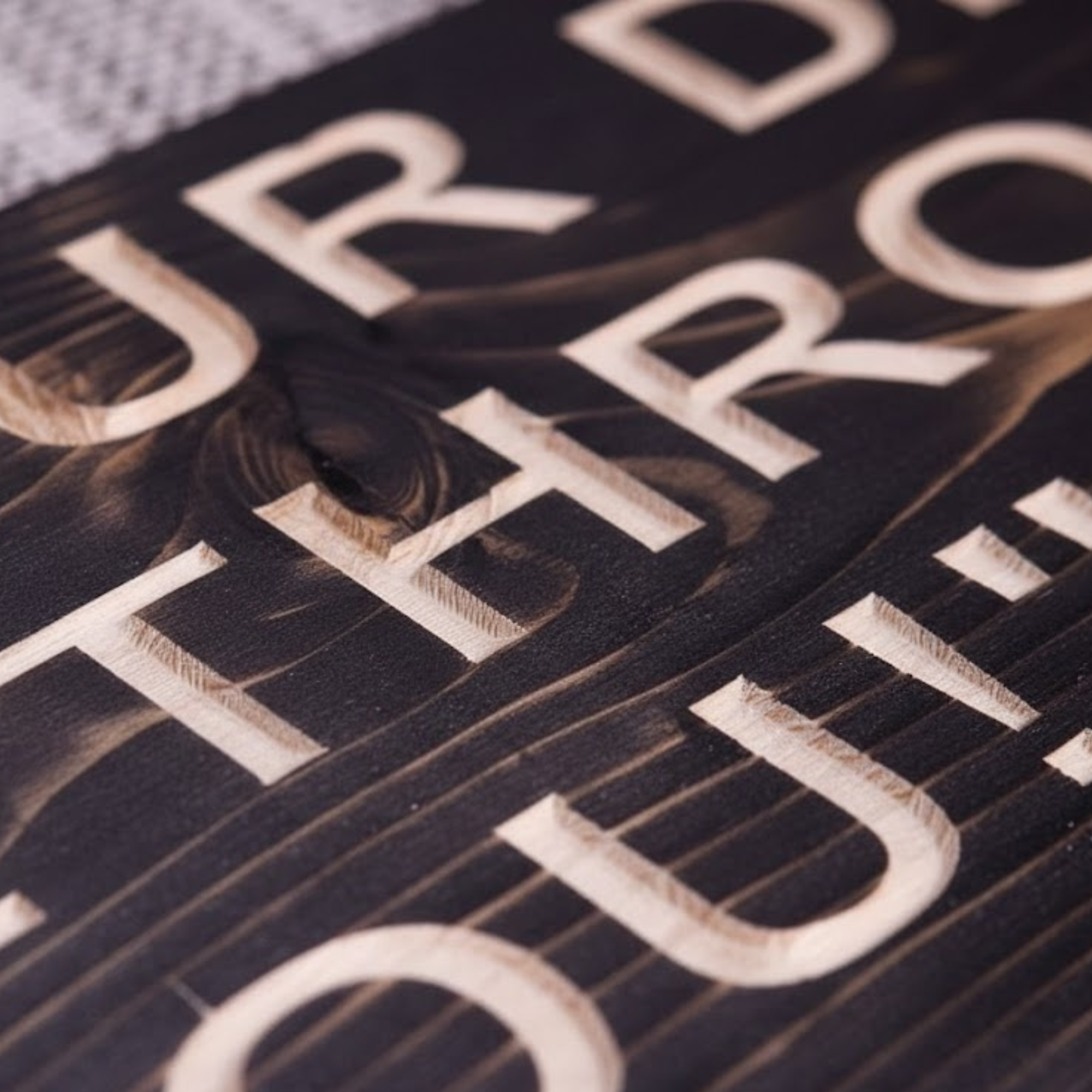 Close-up detail showing the deep CNC-carved lettering of the "Rinse Your Dishes Or I Will Throat Punch You!" wood sign.