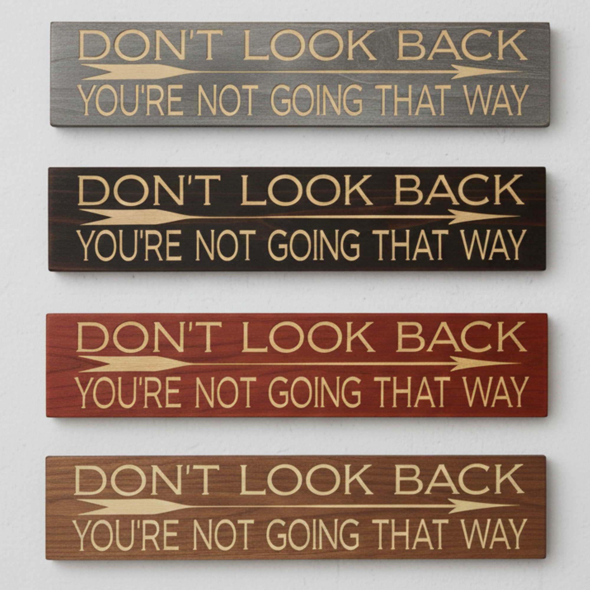 A comparison of four different stain finishes for the "Don't Look Back" sign, including grey, espresso, mahogany, and walnut.