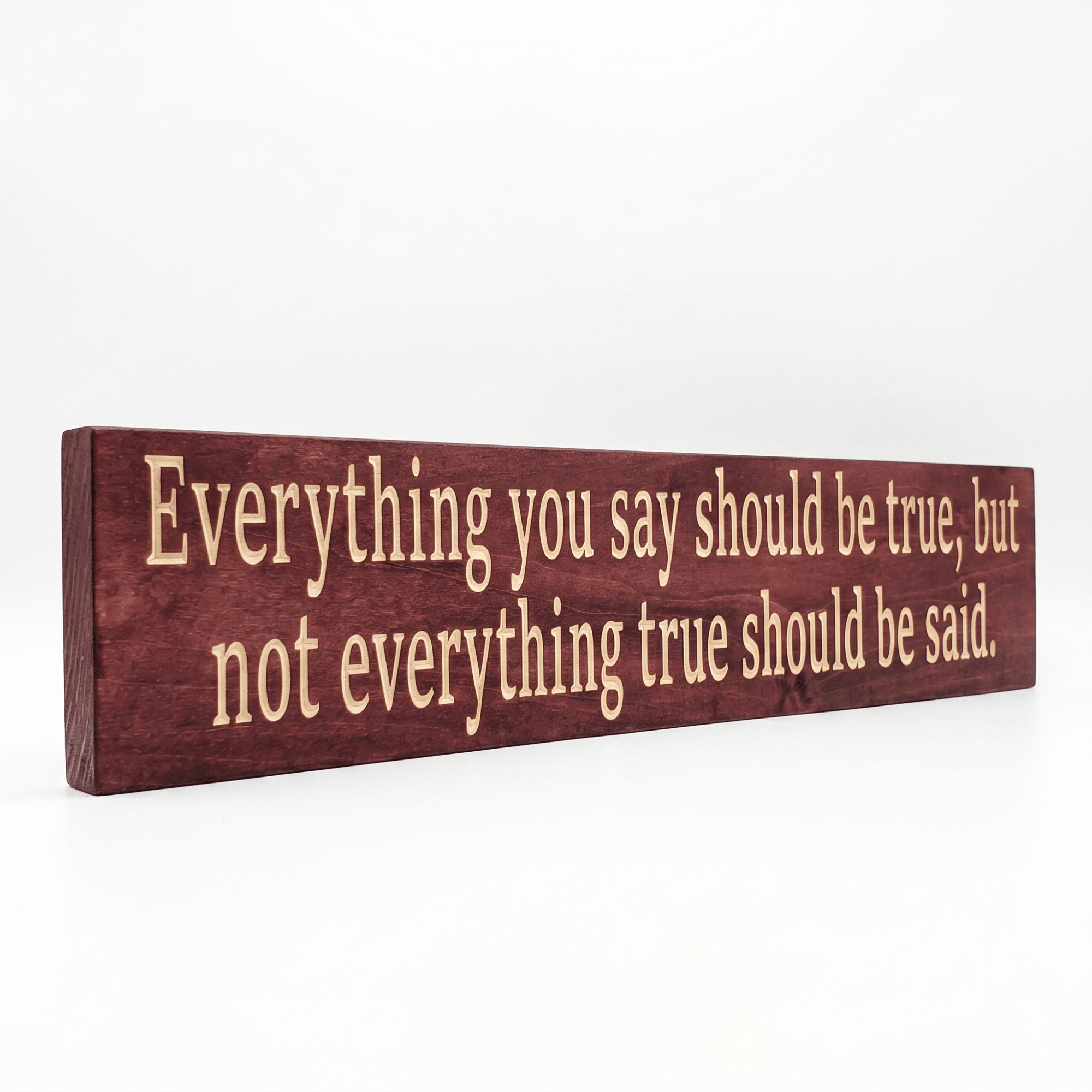 Angled view of the Everything You Say Should Be True wooden quote sign showing dimensional CNC-carved letters and rich Cabernet stain on solid Pine