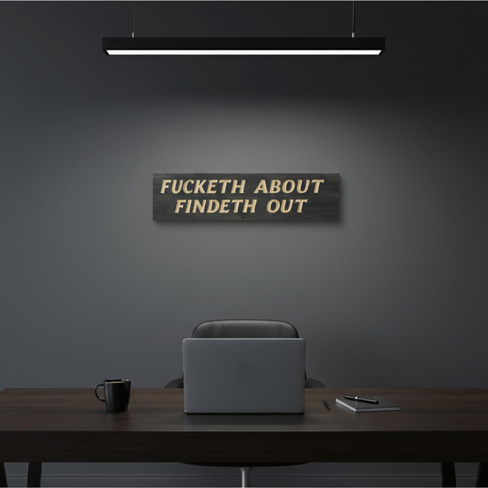 A "Fucketh About Findeth Out" sign on a minimalist desk in a home office with a laptop, showing it's for someone who values direct communication.