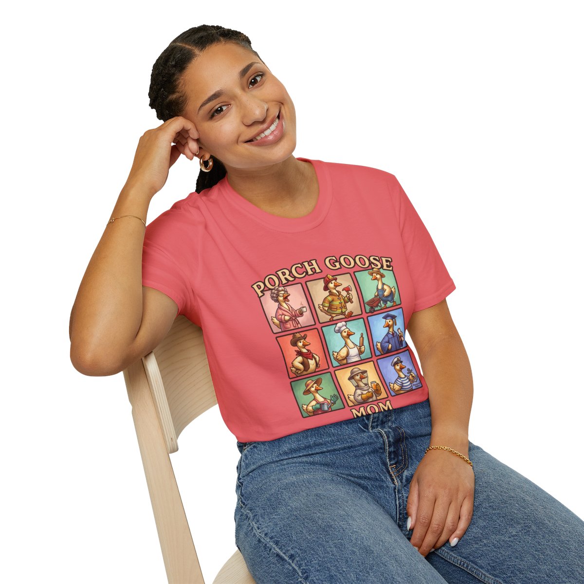 A smiling woman leans back in a chair, wearing the coral Goose Shirt - Porch Goose Mom with nine cartoon geese on the front