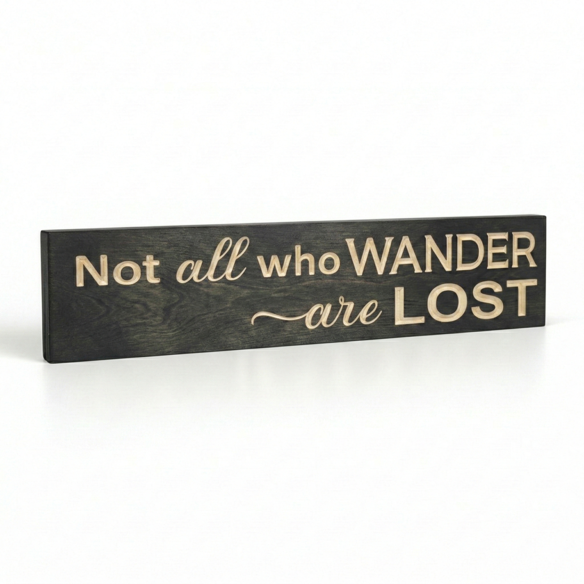 Angled view showcasing the physical 3D depth and natural wood grain of a CNC-engraved "Not all who wander are lost" sign.