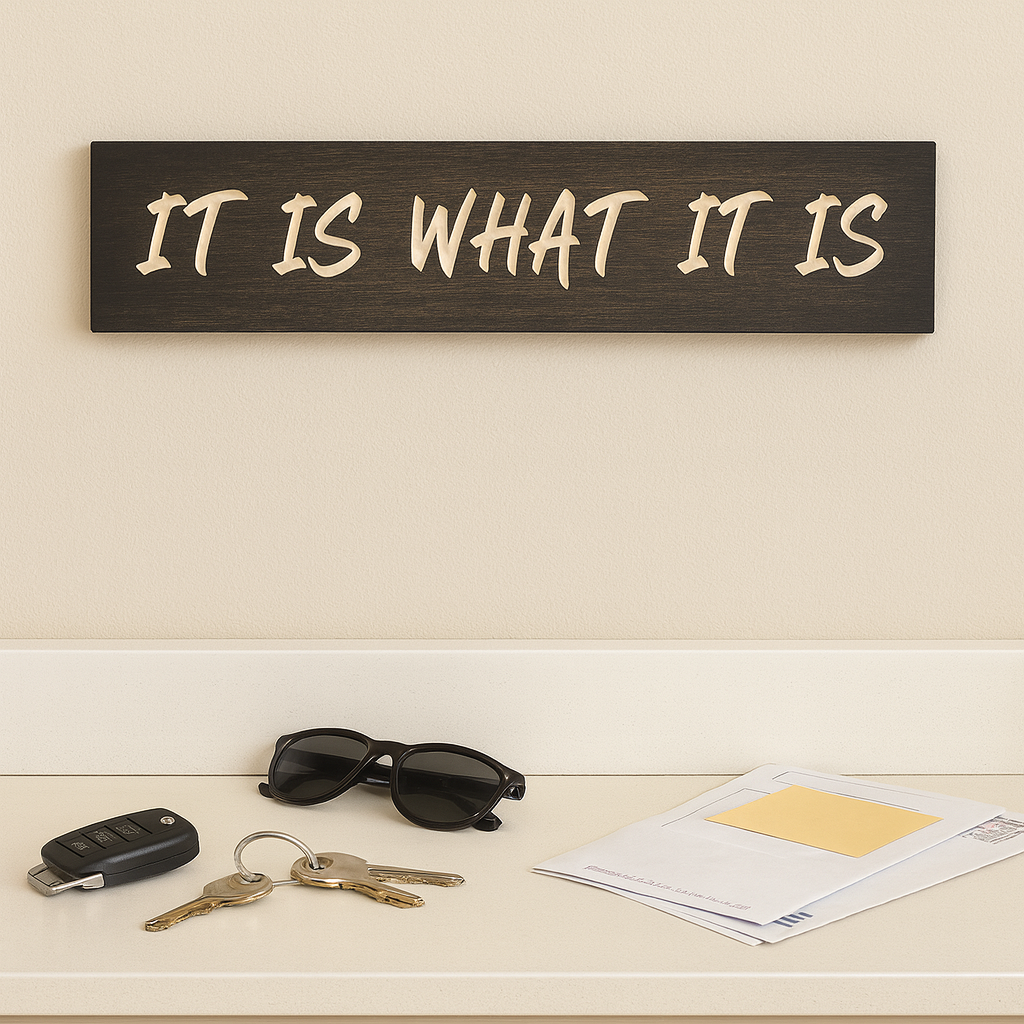 Inspirational farmhouse quote sign “It Is What It Is” displayed in an entryway with keys and mail.