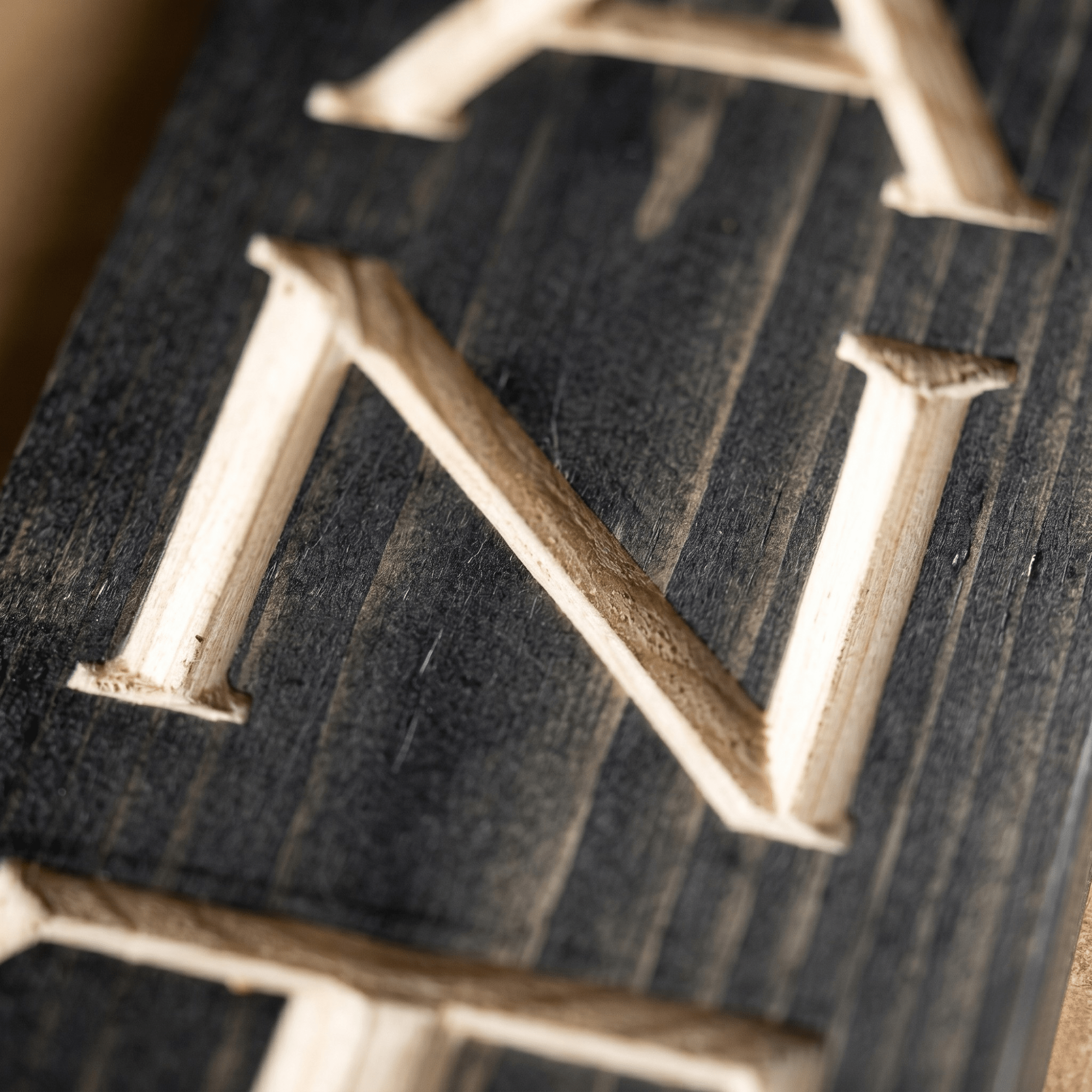 Macro close-up of CNC carved letters on the vertical pantry wood sign revealing real pine grain, hand-finished depth, and authentic wood craftsmanship from Kentucky.