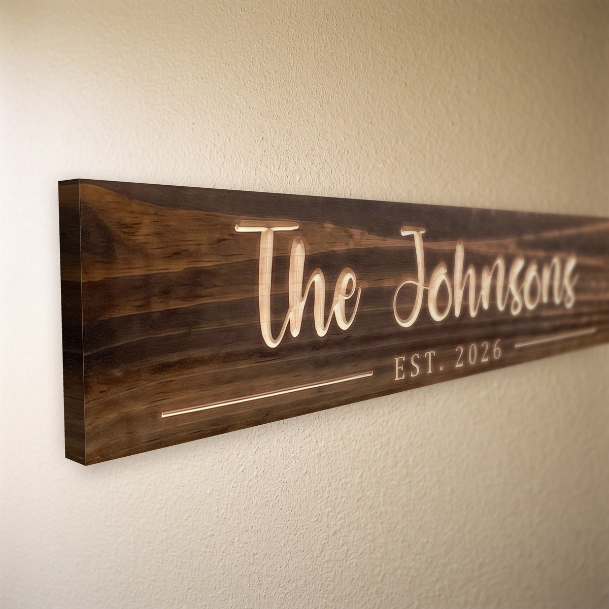 Close-up of the carved letters on the The Johnsons sign, natural pine inside the cuts against the stained grain