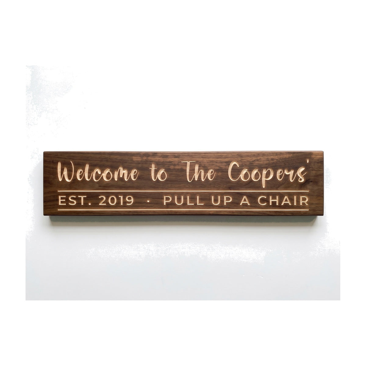 Personalized Welcome to The Coopers' sign carved into solid wood in a Dark Walnut finish, straight on, on a white background (studio photo)