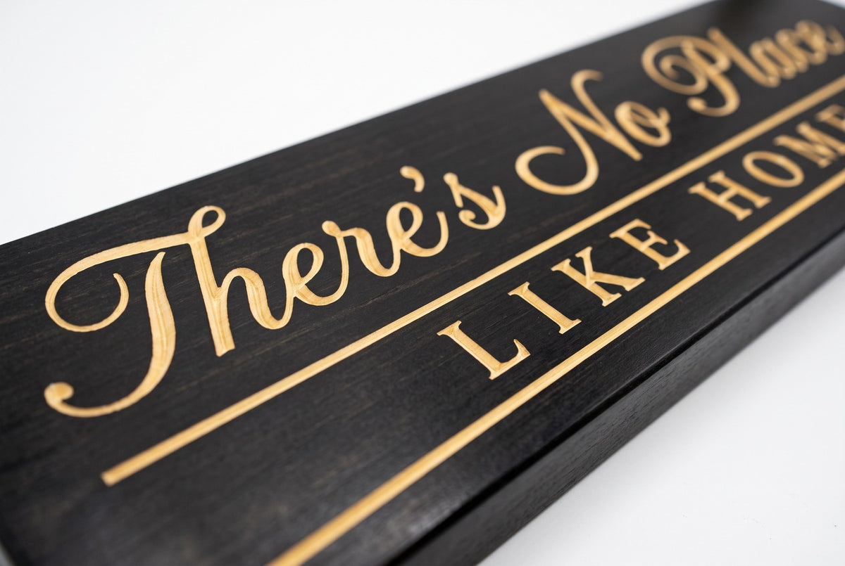There's No Place Like Home carved lettering close-up