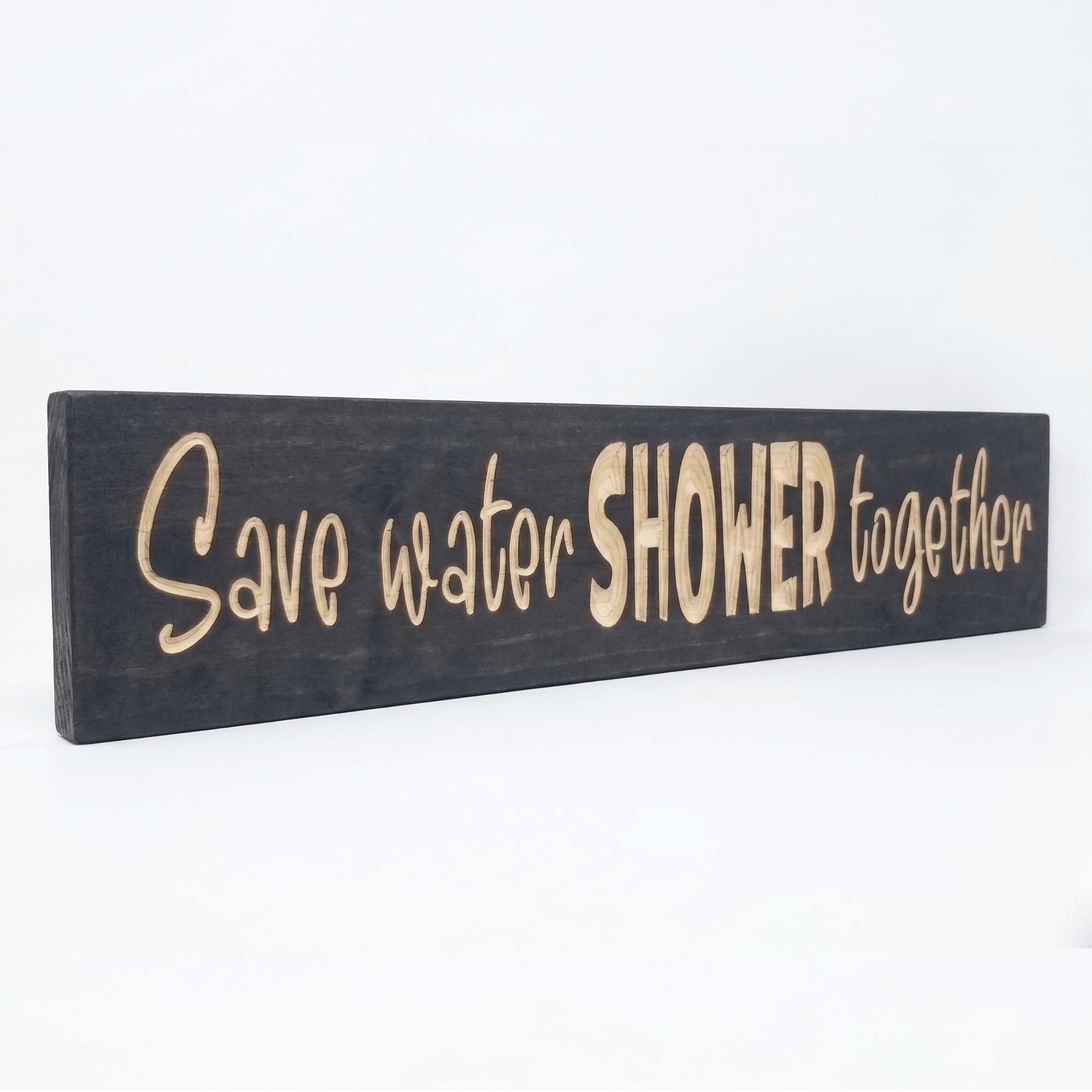 Angled view of the solid wood Save Water Shower Together couples bathroom wall art.