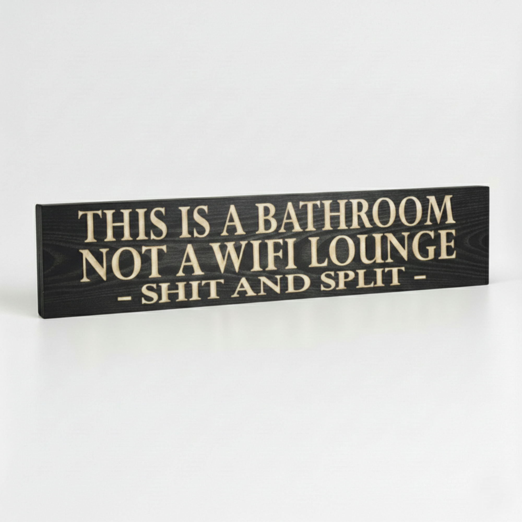 Side profile of the Shit and Split bathroom sign showing the 0.75 inch thick solid hardwood construction and premium finish.