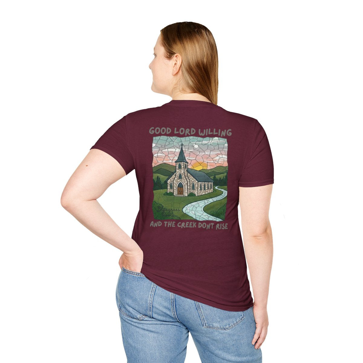 A woman viewed from behind, wearing a maroon Southern Heritage Shirt featuring a "Good Lord Willing and the creek don't rise" church graphic