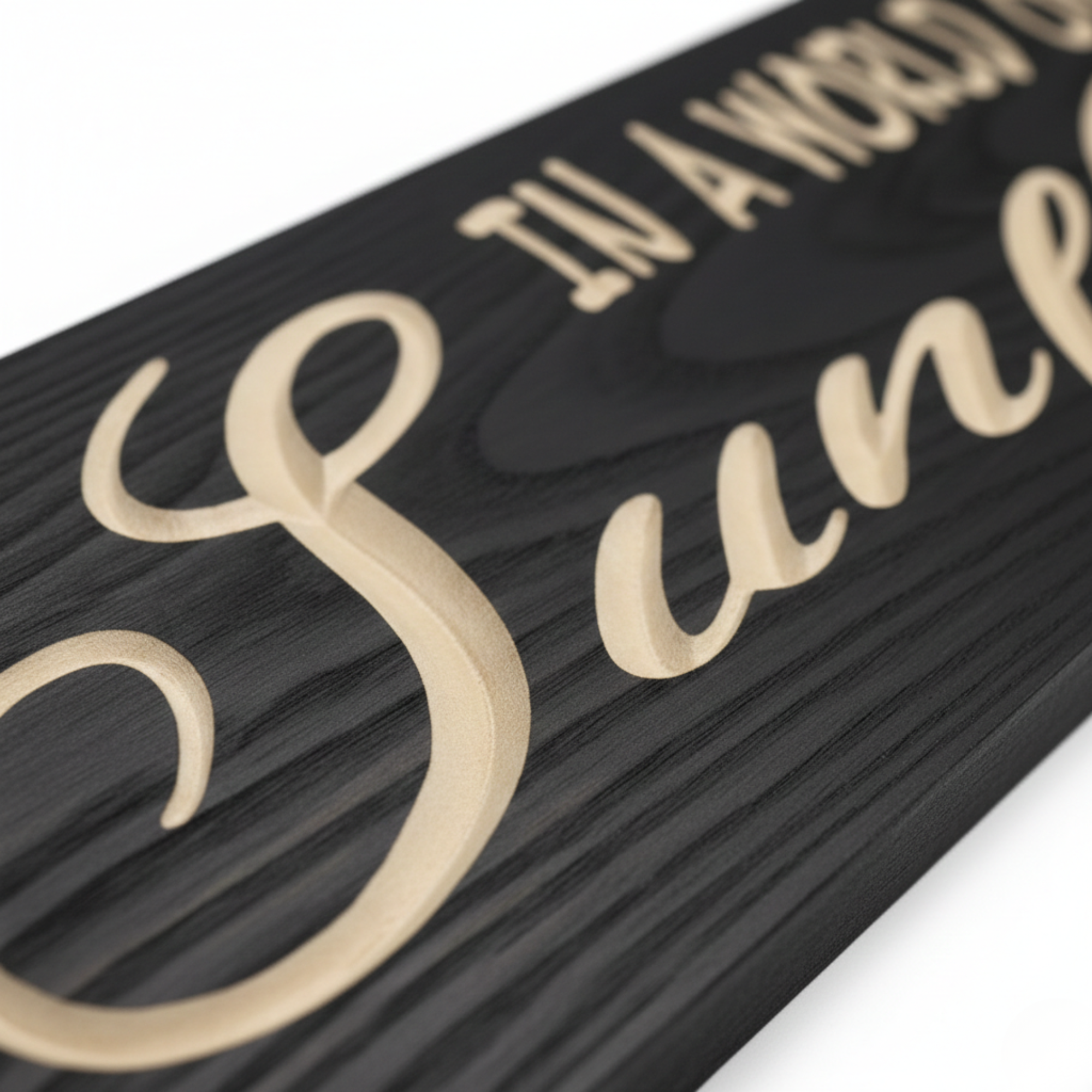 Extreme close-up of the deep CNC v-carve engraving on a solid wood sunflower sign, highlighting the natural grain and crisp white lettering.