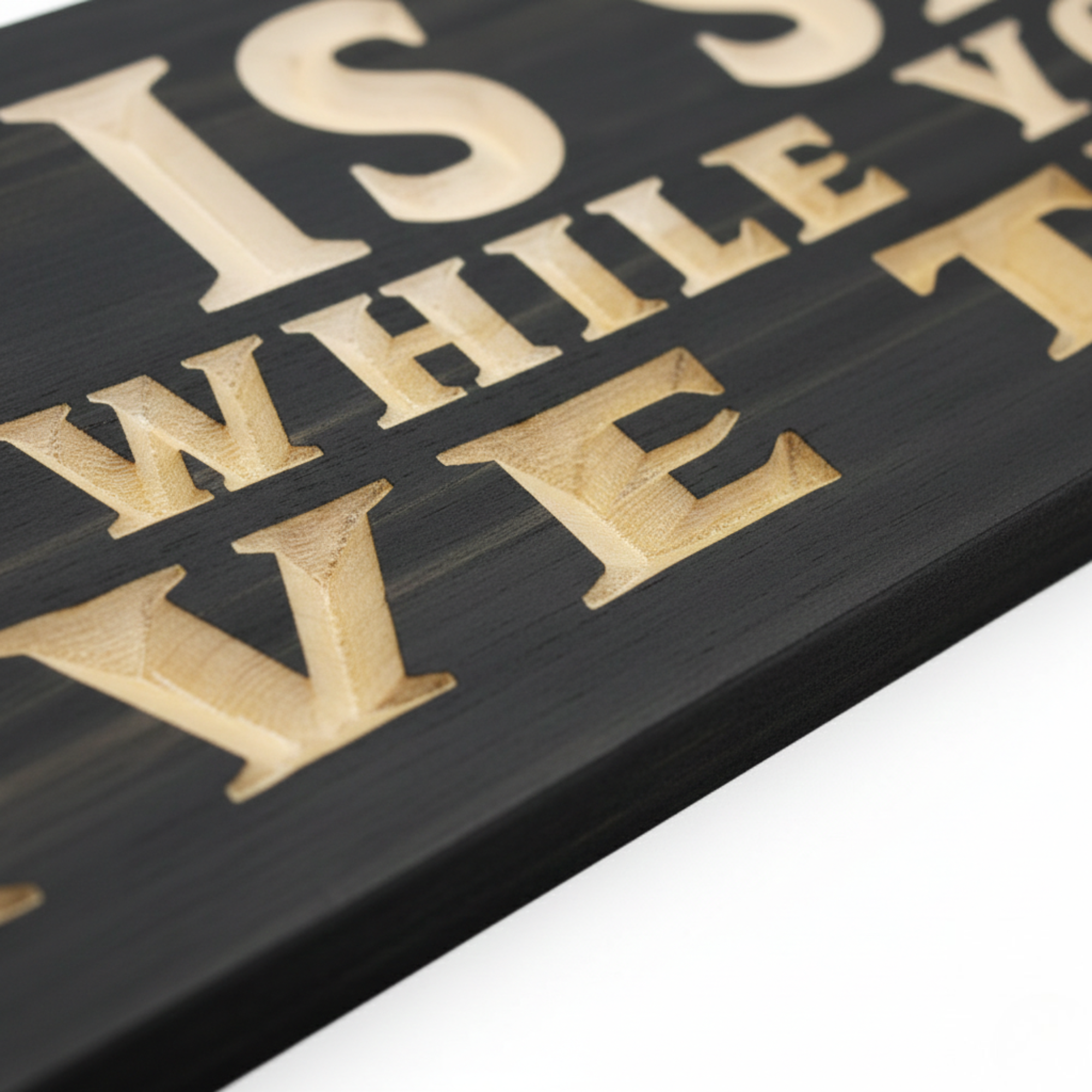 Detailed close-up of deep CNC V-carved lettering on a custom wood sign showing natural pine grain against a dark stain.