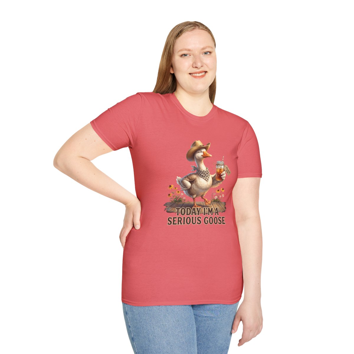 A woman standing with one hand on her hip, smiling, wearing a coral "Sweet Tea Shirt - Today I'm a Serious Goose" tee
