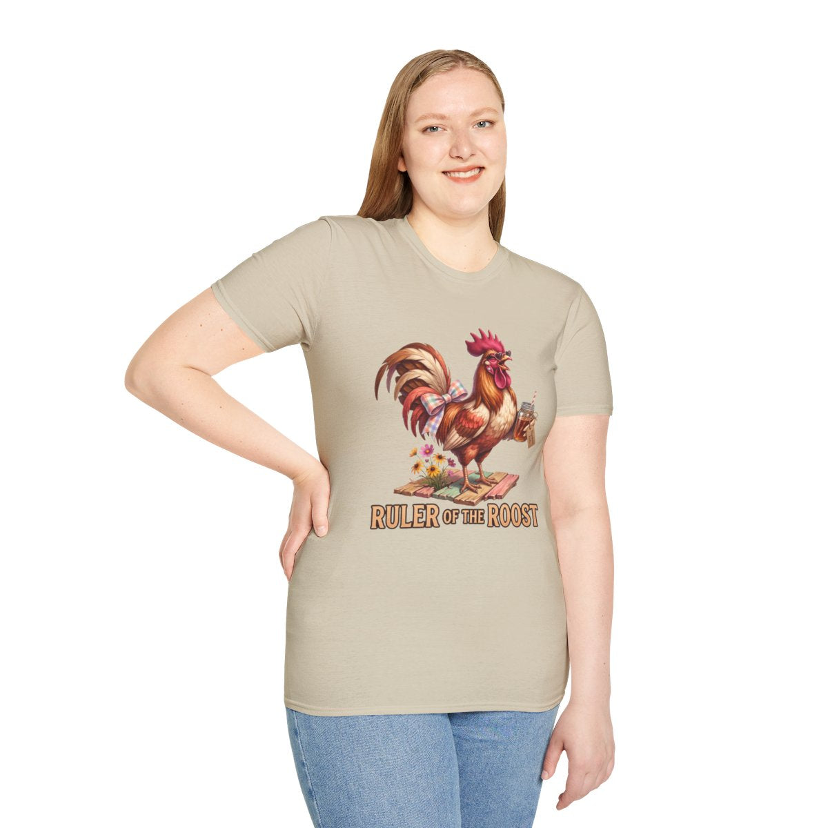 A woman standing, smiling, wearing a beige Rooster Shirt - Ruler of the Roost, with her hand on her hip