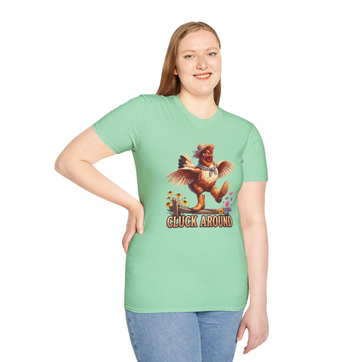A woman stands smiling, wearing a mint green Chicken Shirt - Cluck Around, with her hand on her hip