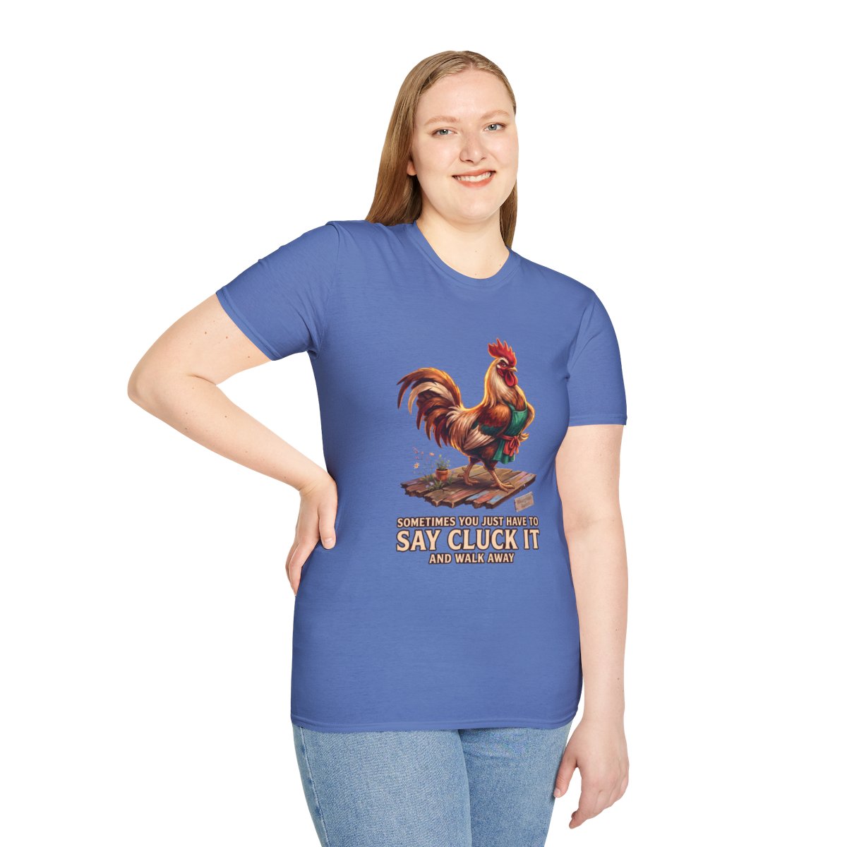 A woman stands smiling, wearing the blue 'Chicken Shirt - Sometimes You Just Have to Say Cluck It' tee, with her hand on her hip