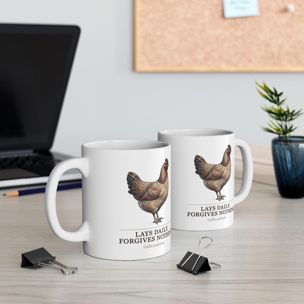 Two Chicken Coffee Mugs on a wooden desk with a laptop, plant, and office supplies in an office setting