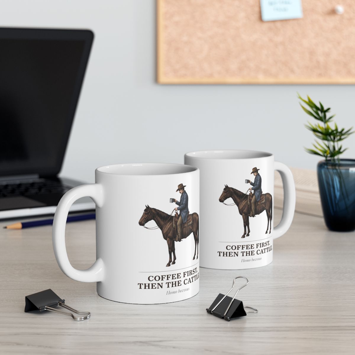Two Cowboy Coffee Mugs are displayed on a light desk, with a laptop and a small plant blurred in the background