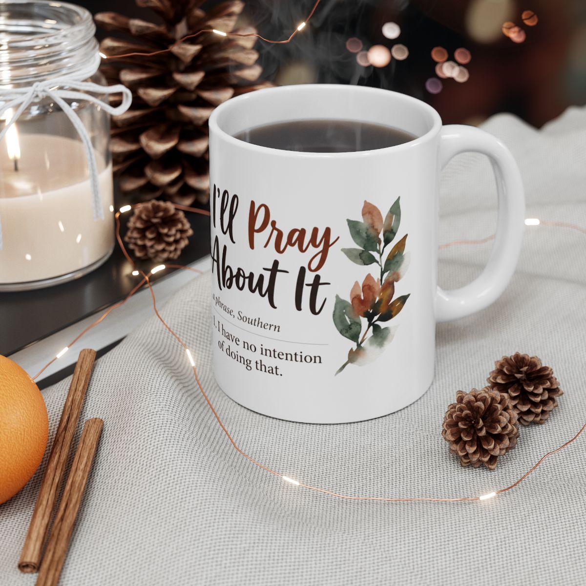 A Sarcastic Coffee Mug filled with dark liquid, surrounded by pinecones, cinnamon sticks, and twinkling lights in a cozy setting