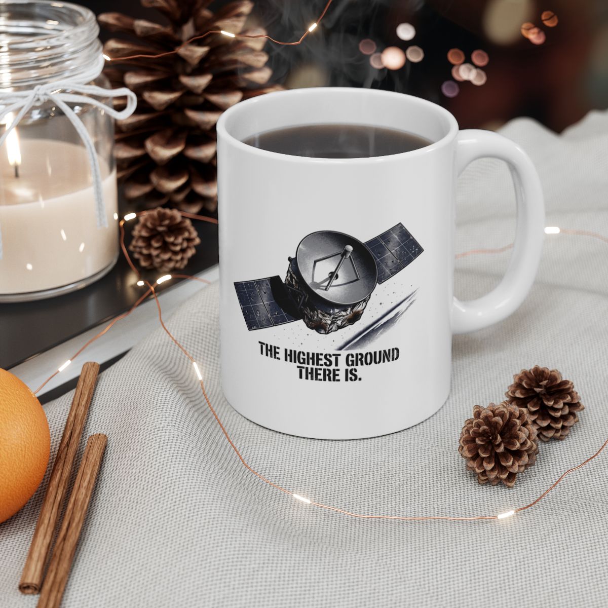 Space Force satellite mug filled with coffee, styled with a candle and pinecones — Bluegrass Gifts mugs