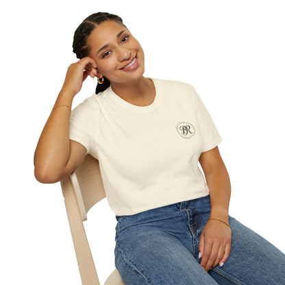 Woman wearing a white t-shirt with a logo and blue jeans, sitting on a chair against a white background